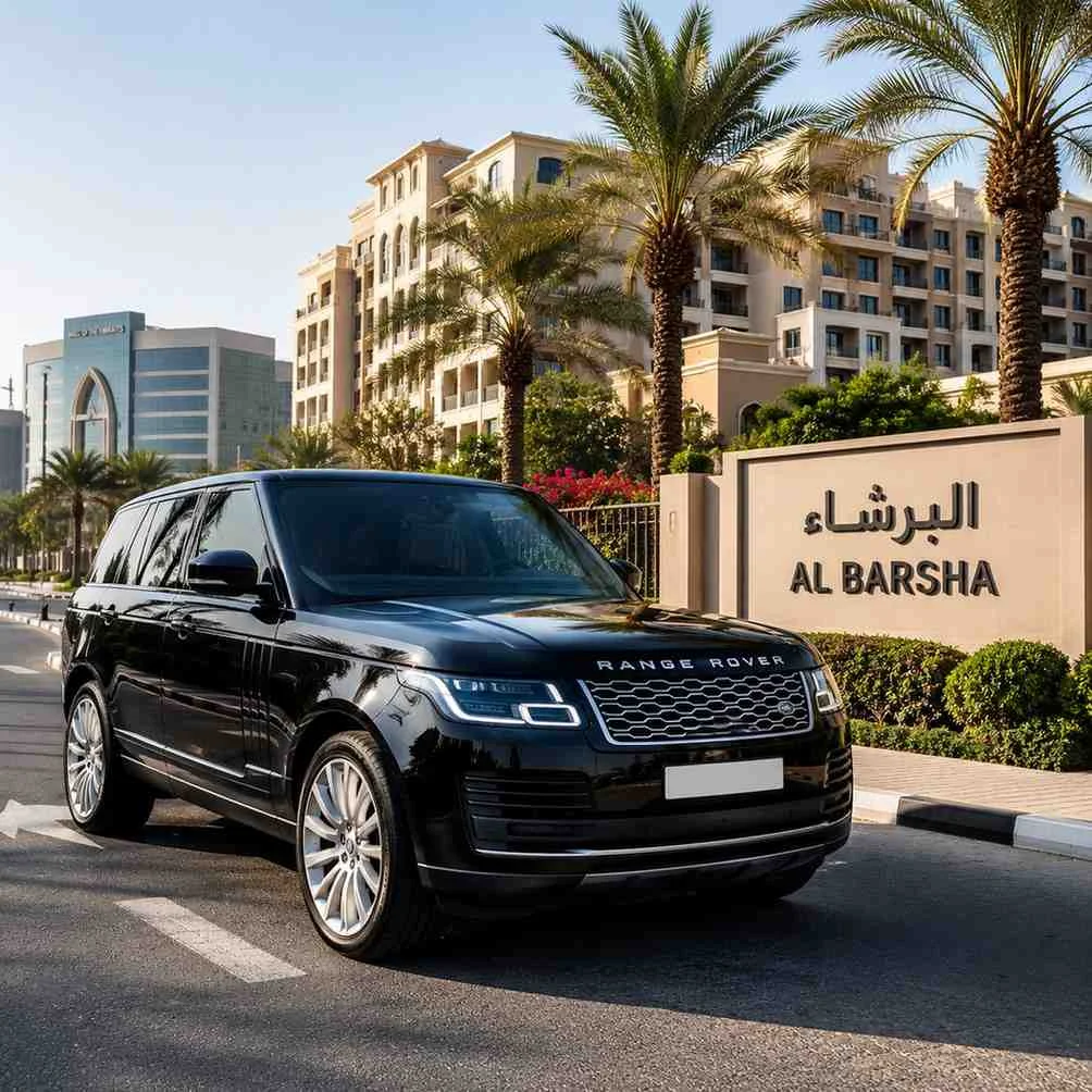 Luxury black Range Rover parked beside the Al Barsha entrance sign in Dubai, showcasing premium SUV car with driver service.